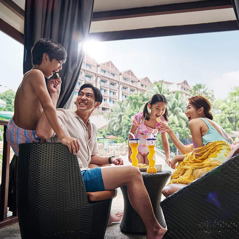 A family enjoying a sunny afternoon under a cabana in Adventure Cove Waterpark.