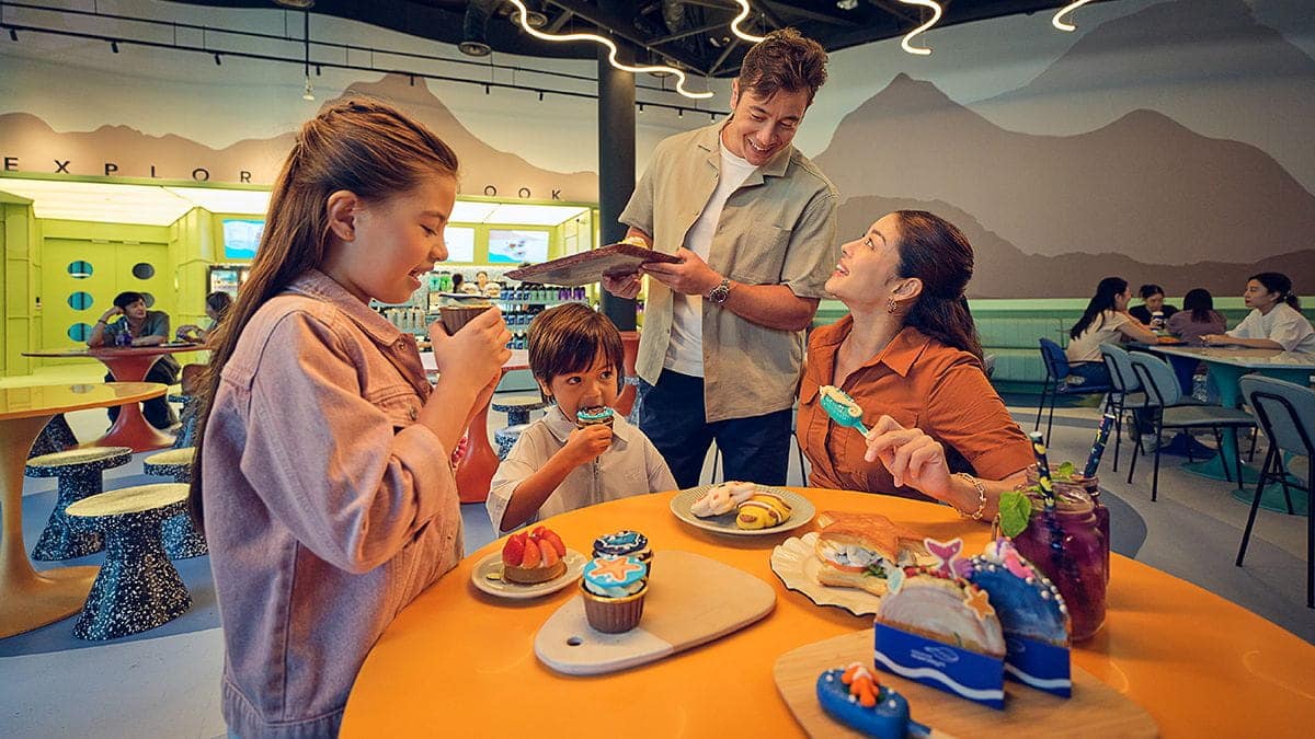 A happy family enjoying a quick meal at Explorer's Nook, a cafe in Singapore Oceanarium.